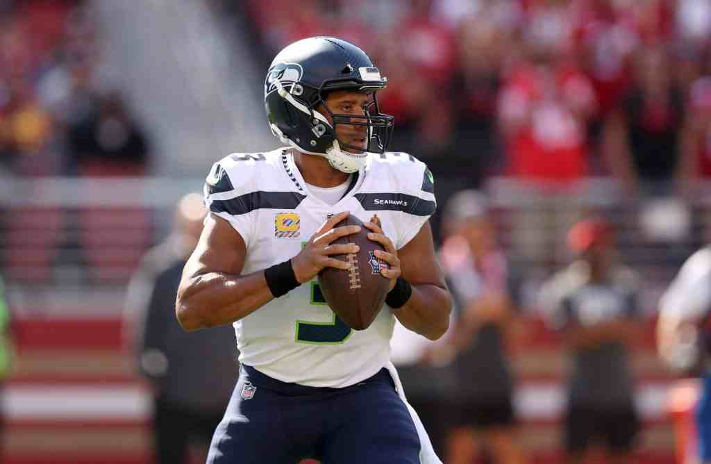 Russell Wilson celebrates becoming the fastest quarterback in the NFL to win 100 games after the Seahawks defeated the 49ers on Sunday.