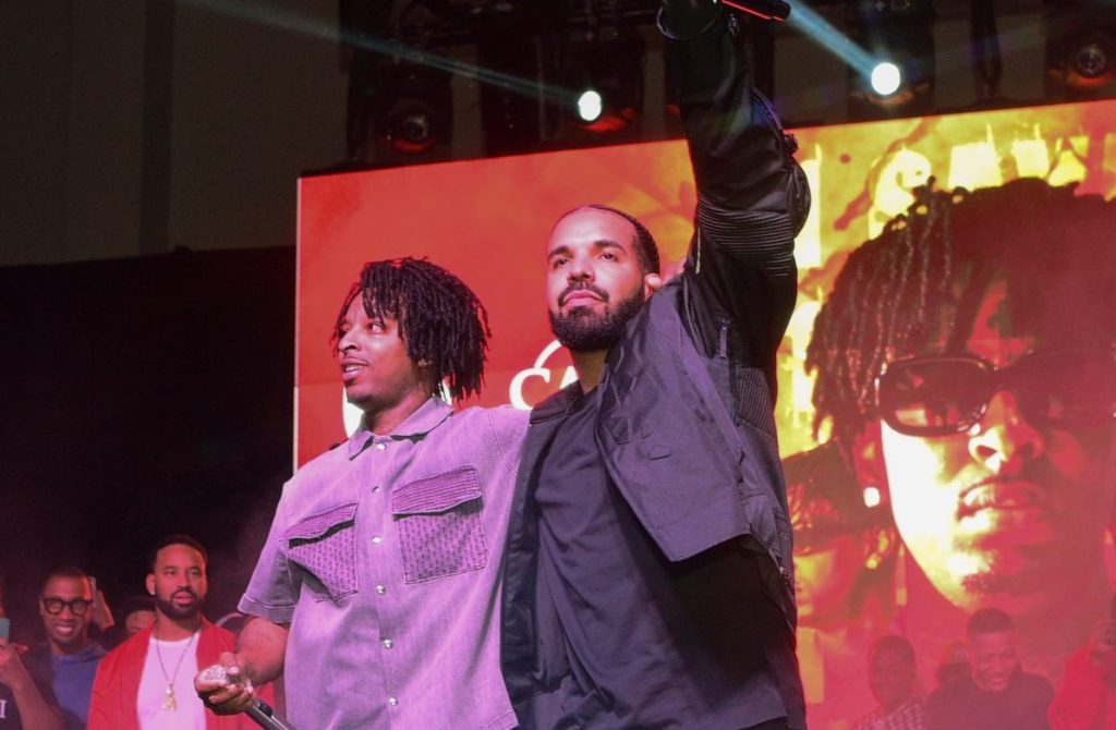 Drake and 21 Savage push back the release of their joint album after Drake's producer catches COVID while mixing the album.