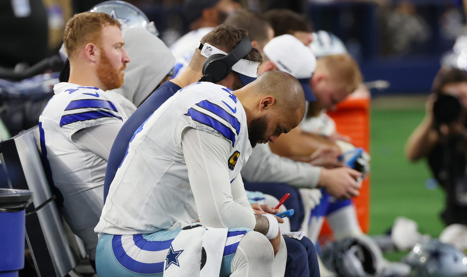 ARLINGTON, TEXAS - JANUARY 14: Dak Prescott #4 of the Dallas Cowboys sits on the bench during the fourth quarter of the NFC Wild Card Playoff game against the Green Bay Packers at AT&T Stadium on January 14, 2024 in Arlington, Texas. The Packers defeated the Cowboys 48-32.