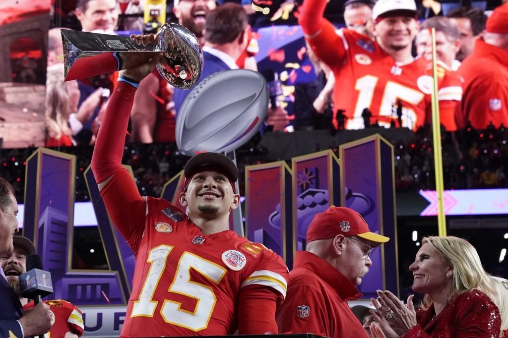 TOPSHOT - Kansas City Chiefs' quarterback #15 Patrick Mahomes celebrates with the trophy after the Chiefs won Super Bowl LVIII against the San Francisco 49ers at Allegiant Stadium in Las Vegas, Nevada, February 11, 2024