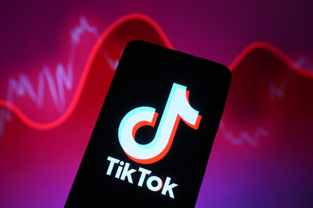 UKRAINE - 2024/03/05: In this photo illustration, a TikTok logo is seen displayed on a smartphone screen. Facebook and Instagram of Meta are down worldwide, and users unable to access accounts, reportedly by media. WhatsApp and TikTok also crashed, reported by some media.