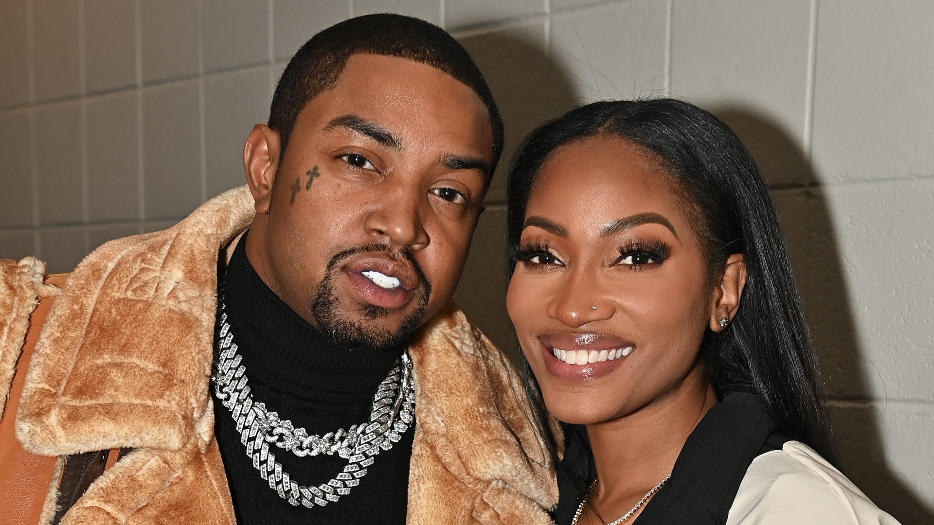 ATLANTA, GEORGIA - JANUARY 30: Lil Scrappy and Erica Dixon attend the game between Los Angeles Lakers and the Atlanta Hawks at State Farm Arena on January 30, 2024 in Atlanta, Georgia.